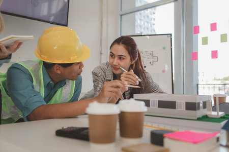 the architect and his team are meeting with the construction supervisor to brainstorm on how to...