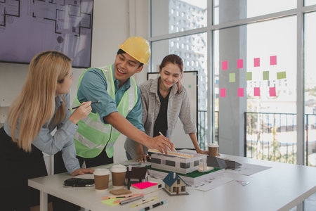 the architect and his team are meeting with the construction supervisor to brainstorm on how to...