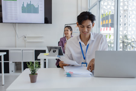 the atmosphere of the company's employees working together, the finance department staff work with the accounting department, a group of businessmen are exchanging insights with each otherの写真素材