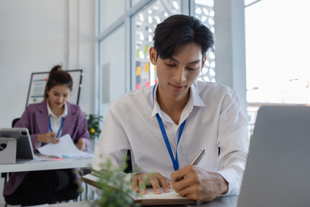 the atmosphere of the company's employees working together, the finance department staff work with the accounting department, a group of businessmen are exchanging insights with each otherの写真素材