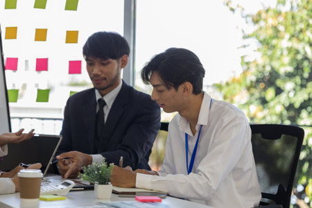 entrepreneurs brainstorm together to develop new products in a conference room, businesspeople share...