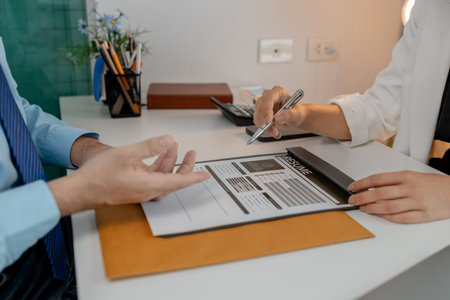 the head of human resources at an accounting firm is interviewing a candidate for a marketing position, resume, recruitment, hr, job interview, he submits his resume to the HR department in the officeの写真素材