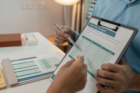 the company's auditing staff is checking the documents for accuracy in the office, businessman is explaining information in a document to his partner, graph, entrepreneur, marketingの写真素材