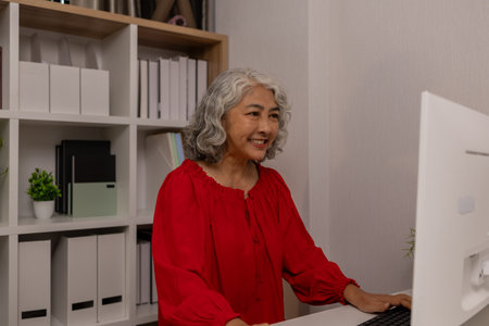 a mother spends her retirement years comfortably in her home, a grandmother spends her free time during the day doing various activities in the living roomの写真素材