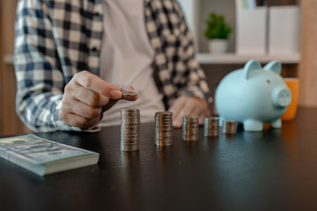 he is saving money for his future plans, putting some if his income in a piggy bank, he is saving...