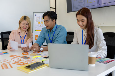 ux, ui, web and mobile app designers are discussing the look and feel of the website or app they are...