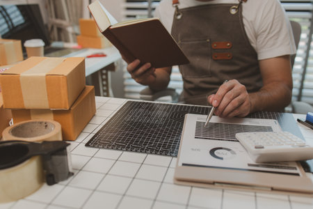 a packer is working in a room at a shipping company, an entrepreneur is a small business owner selling small items online, a businessman is working in his shipping company, parcel, productの写真素材