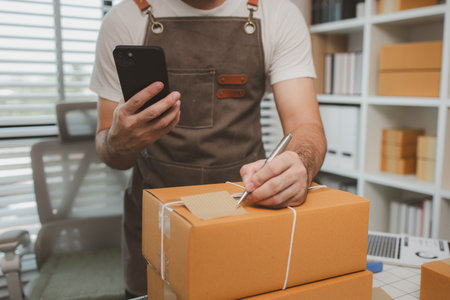 he is checking the boxes in the packing room, a small business owner is preparing boxes to ship to customers, product, e-business, entrepreneurs in online sales and export businessesの写真素材