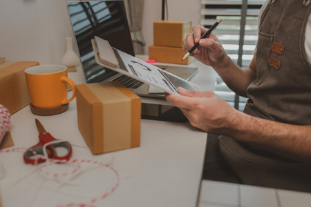 an entrepreneur has his own small online business, the business owner checks the package before delivering it to the customer, parcel, product, small business, e-businessの写真素材