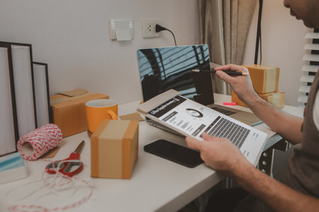 an entrepreneur has his own small online business, the business owner checks the package before delivering it to the customer, parcel, product, small business, e-businessの写真素材