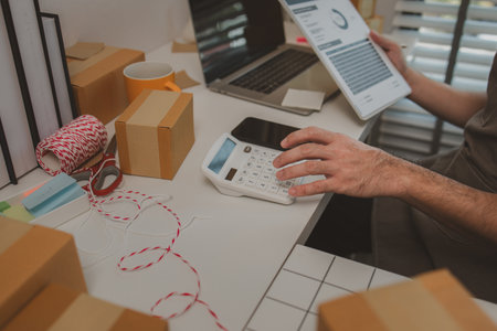 an entrepreneur has his own small online business, the business owner checks the package before delivering it to the customer, parcel, product, small business, e-businessの写真素材