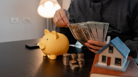 a man uses his savings to buy his dream home, this man plans his finances to buy a home, he uses his savings to buy a home as an investment, financial, money, property, paymentの写真素材
