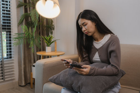 she feels stressed about spending on her credit cards when she sees the outstanding balance, the charges she makes form her shopping cards stress her out, debit, debit card, spendの写真素材