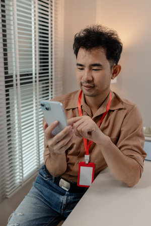 this businessman is relaxing in his office after long day work with his phone, he is spent his free...