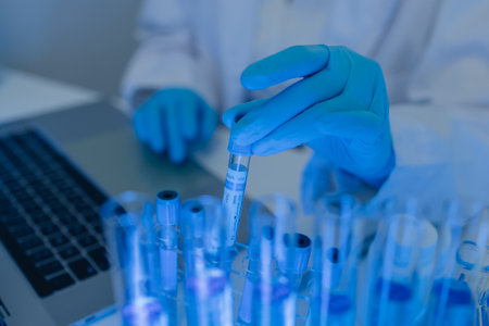 a female chemist is testing various liquid compounds in a lab, a scientist is doing research on the...