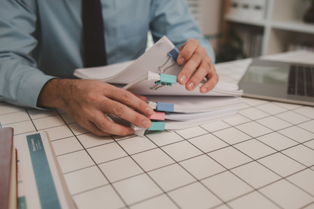 a businessman is handling documents in the office, an accountant is collecting documents, a...