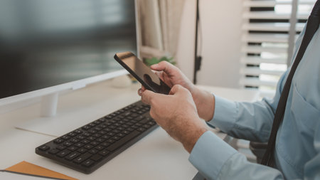 an entrepreneur is working diligently in an office, a businessman is using a smartphone to take a photo of a document, the manager is reviewing a document, marketing, company, accountantの写真素材