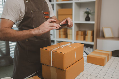 he is checking the boxes in the packing room, a small business owner is preparing boxes to ship to...