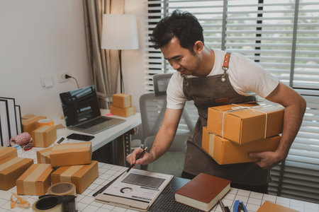 an entrepreneur has his own small online business, the business owner checks the package before...