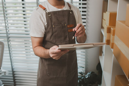 a businessman has a small business selling product online, an online business owner is checking the...