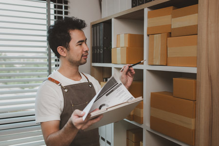 a businessman has a small business selling product online, an online business owner is checking the...