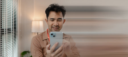 this businessman is relaxing in his office after long day work with his phone, he is spending his free time on his phone in the office, relax, head of marketing feels relaxed in his office with his phoneの写真素材