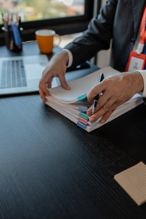 an accounting and financial officer is working on documents in the office, a businessman is...