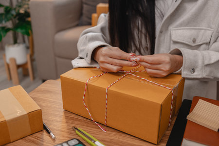 she is packing parcel to send to all customers, this entrepreneur own a small business, sme, selling...