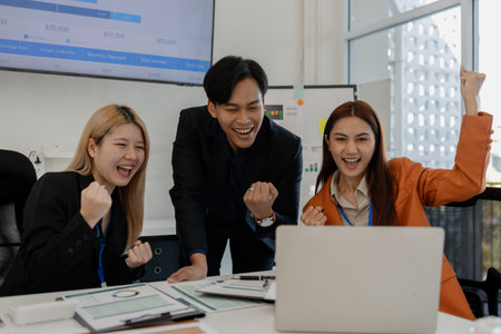 the group of business people showed their joy by clapping and giving high fives because of their success in business, joyful, cheerful, brainstorming in the meeting room, businessmanの写真素材