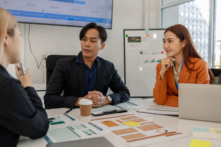 one of marketing team is explaining the presentation to the team, group of businessman are meeting in the office, these entrepreneur are brainstorming about their business project, finance, accountingの写真素材