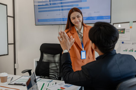 the group of business people showed their joy by clapping and giving high fives because of their success in business, joyful, cheerful, brainstorming in the meeting room, businessmanの写真素材