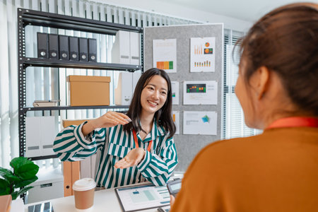 A group of professionals engaged in a collaborative business meeting, exchanging innovative ideas and strategies to build growth and success in a modern startup environment.の写真素材