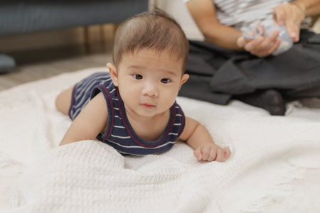 A father spends quality time with his baby, playing and bonding through gentle care and fun moments...