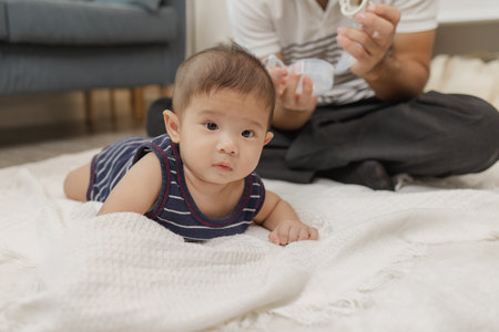A father spends quality time with his baby, playing and bonding through gentle care and fun moments...