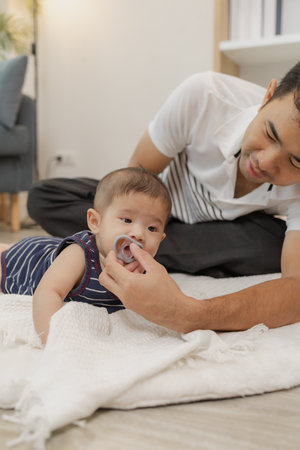 A father spends quality time with his baby, playing and bonding through gentle care and fun moments...