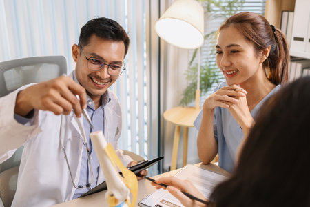 Medical professionals collaborating during a meeting to discuss patient care plans and treatment strategies. Doctors and nurses share expertise and analyze clinical data for better healthcare outcomesの写真素材