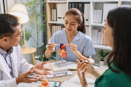 Medical professionals collaborating during a meeting to discuss patient care plans and treatment strategies. Doctors and nurses share expertise and analyze clinical data for better healthcare outcomesの写真素材