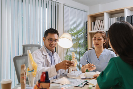 Medical professionals collaborating during a meeting to discuss patient care plans and treatment strategies. Doctors and nurses share expertise and analyze clinical data for better healthcare outcomesの写真素材