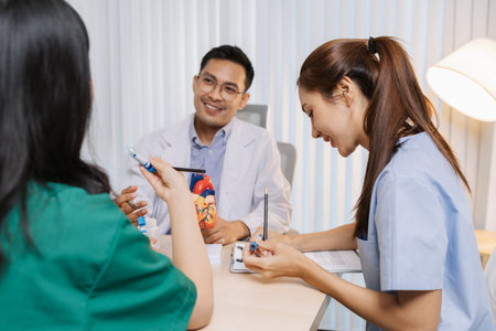 Group of doctors and nurses consulting about a complex patient case in hospital office. Team analyzing medical data and discussing diagnostic plans for accurate and efficient treatment.の写真素材