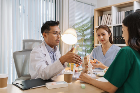 Doctor teaching medical team during a clinical session. Healthcare professionals learn together,...