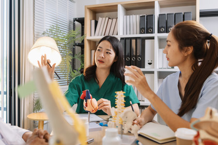 Group of doctors and nurses consulting about a complex patient case in hospital office. Team analyzing medical data and discussing diagnostic plans for accurate and efficient treatment.の写真素材