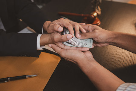 A professional lawyer discussing legal matters with a client in an office, providing legal advice and document review services, symbolizing justice, trust, and professional consultation.の写真素材