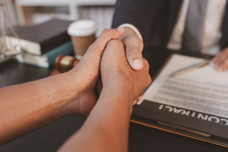 A professional lawyer discussing legal matters with a client in an office, providing legal advice and document review services, symbolizing justice, trust, and professional consultation.の写真素材
