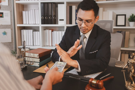 A professional lawyer discussing legal matters with a client in an office, providing legal advice and document review services, symbolizing justice, trust, and professional consultation.の写真素材
