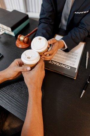 A professional lawyer discussing legal matters with a client in an office, providing legal advice and document review services, symbolizing justice, trust, and professional consultation.の写真素材