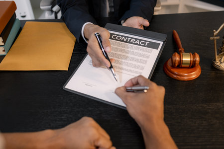 A professional lawyer discussing legal matters with a client in an office, providing legal advice and document review services, symbolizing justice, trust, and professional consultation.の写真素材