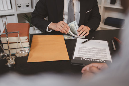 A professional lawyer discussing legal matters with a client in an office, providing legal advice and document review services, symbolizing justice, trust, and professional consultation.の写真素材