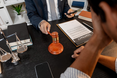 A professional lawyer discussing legal matters with a client in an office, providing legal advice and document review services, symbolizing justice, trust, and professional consultation.の写真素材