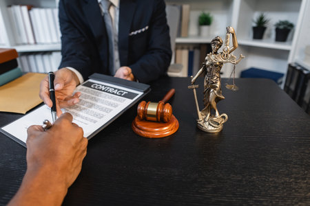 A professional lawyer discussing legal matters with a client in an office, providing legal advice and document review services, symbolizing justice, trust, and professional consultation.の写真素材