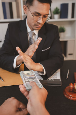 A professional lawyer discussing legal matters with a client in an office, providing legal advice and document review services, symbolizing justice, trust, and professional consultation.の写真素材